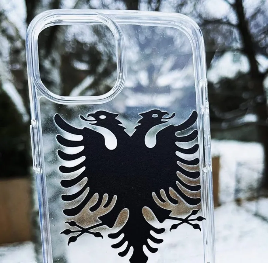 Close-up of the black Albanian double-headed eagle printed on a clear phone case